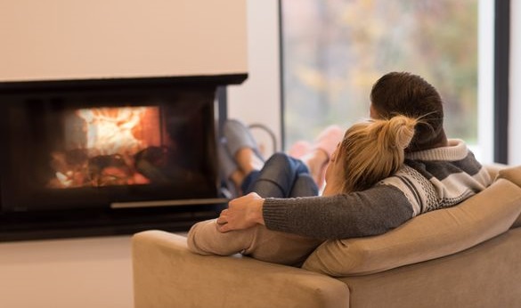 Young romantic couple sitting on sofa